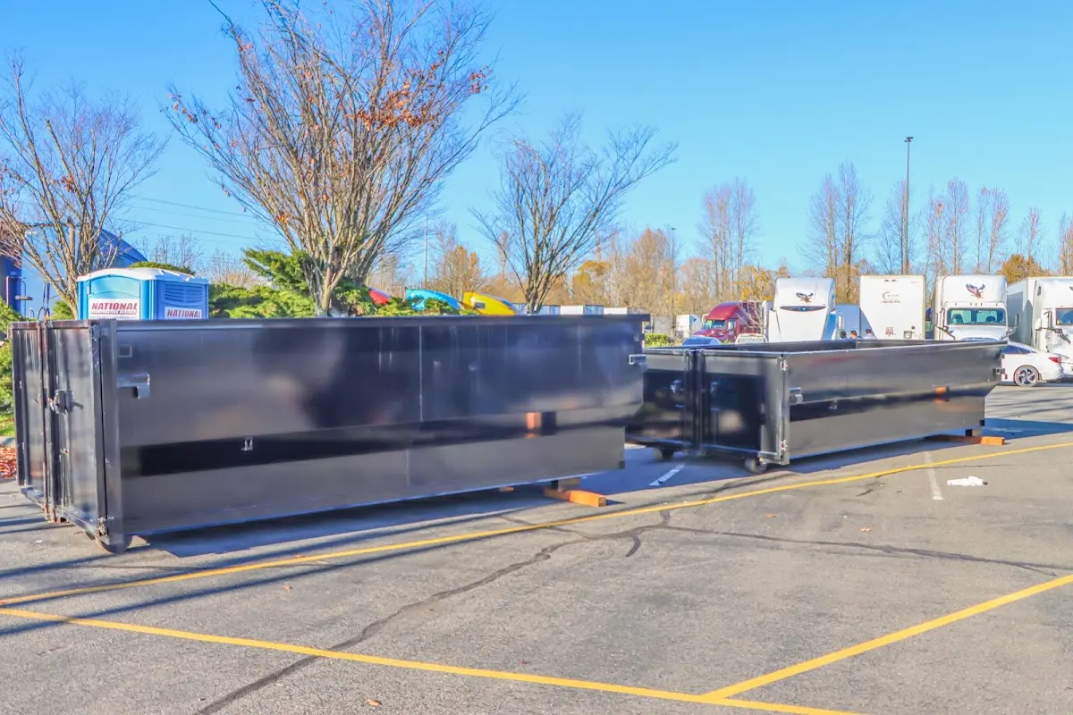 Professional dumpster rental service with roll-off container on residential driveway in Chain Lake